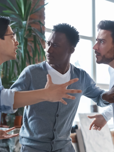Office conflict. Angry multiracial young men fighting at workplace, afro guy standing between them, CIT Training Presentation