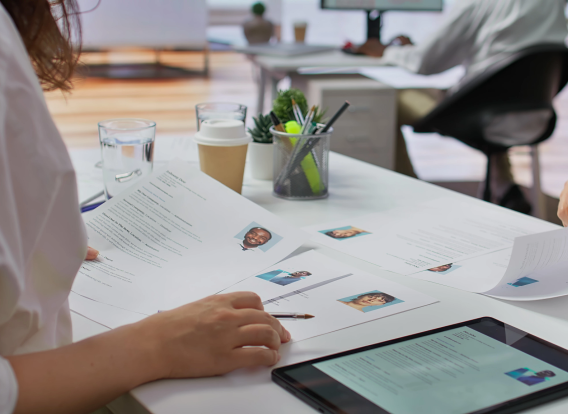 A recruiter checking over different types of resumes for qualifications.